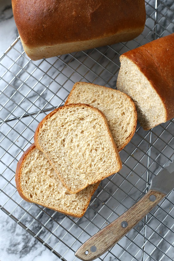 Easy recipe for delicious homemade honey whole wheat bread uses a bread machine to make the dough. Shape into loaves and bake. Perfect for slicing too.