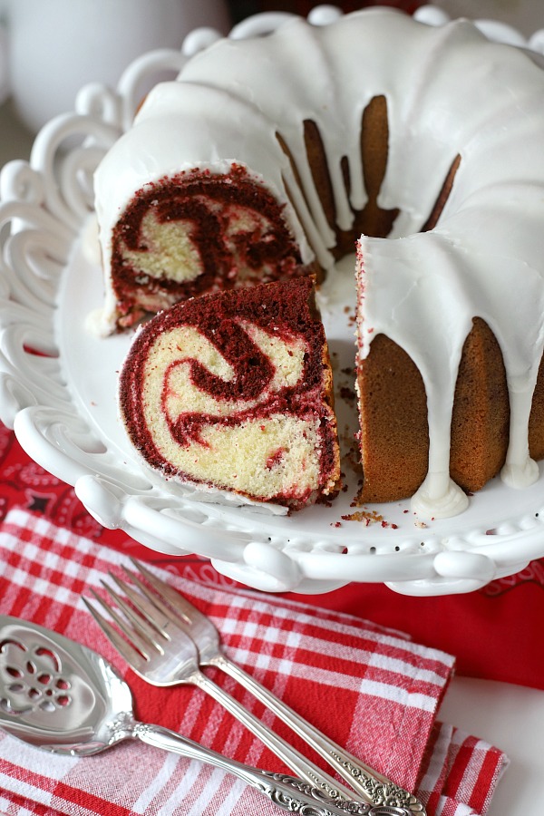 From scratch recipe for a moist red velvet marbled cake made in a Bundt pan has a lovely icing just right for Valentine's Day or celebrating a birthday.