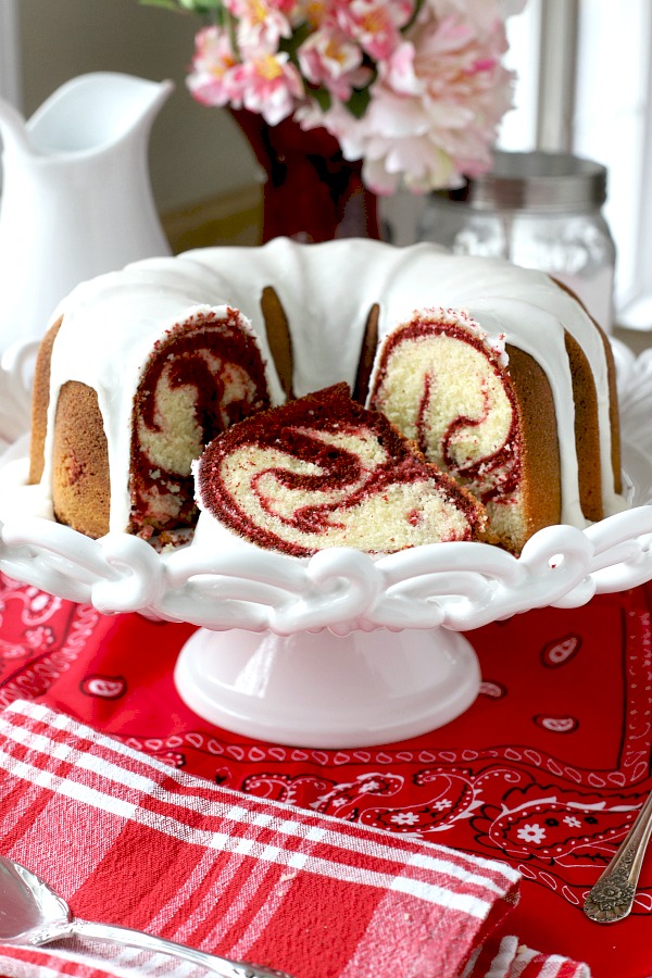 From scratch recipe for a moist red velvet marbled cake made in a Bundt pan has a lovely icing just right for Valentine's Day or celebrating a birthday.