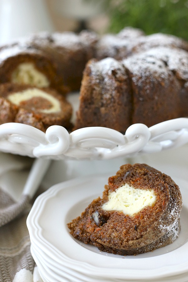 Filled with a tunnel of sweetened cream cheese, surprise carrot bundt cake is moist and delicious dessert. An easy recipe that needs only a dusting of sugar on top.