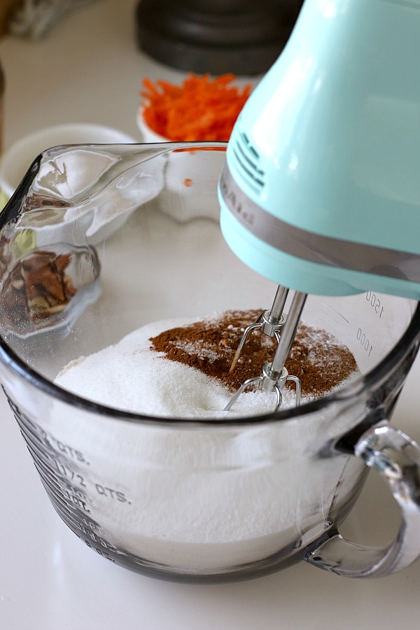 Filled with a tunnel of sweetened cream cheese, surprise carrot bundt cake is moist and delicious dessert. An easy recipe that needs only a dusting of sugar on top.