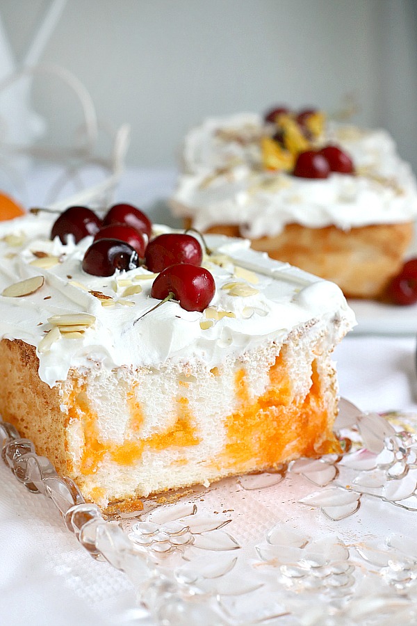 Light and delicious, Orange Angel Food cake begins with a box mix. Easy recipe for a poke cake using Jell-O and whipped topping for a refreshing dessert.