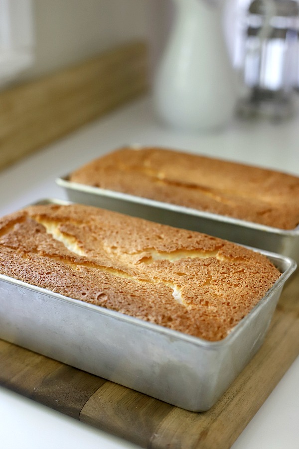 A light dessert and easy recipe for orange angel food cake begins with a box mix. Poke holes throughout the baked cake and pour in Jell-O. Top with whipped topping and serve.