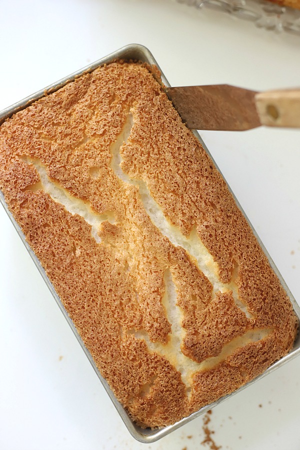 A light dessert and easy recipe for orange angel food cake begins with a box mix. Poke holes throughout the baked cake and pour in Jell-O. Top with whipped topping and serve.