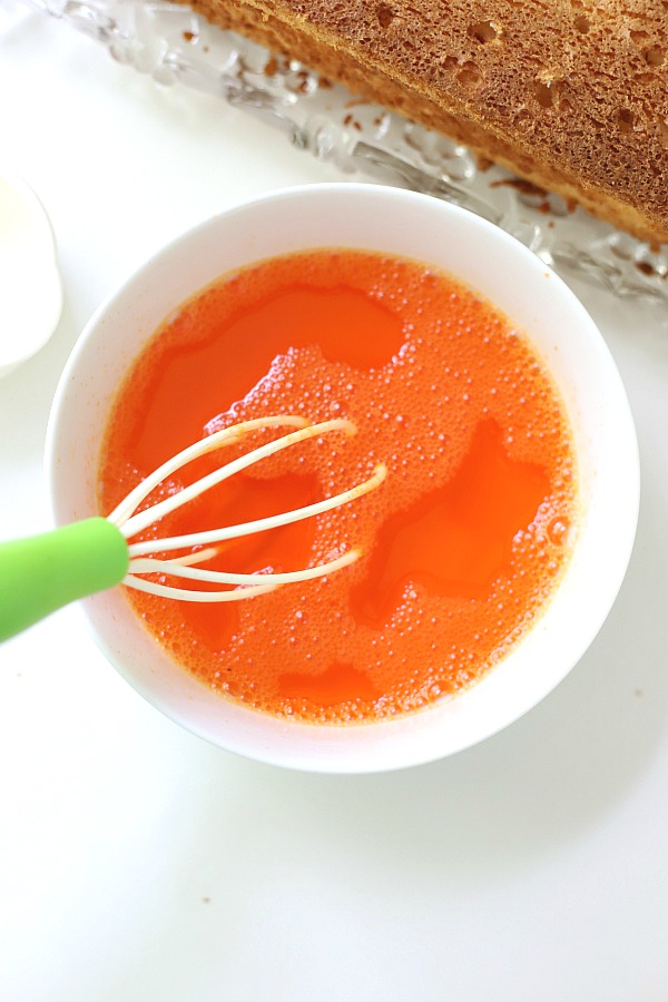 A light dessert and easy recipe for orange angel food cake begins with a box mix. Poke holes throughout the baked cake and pour in Jell-O. Top with whipped topping and serve.