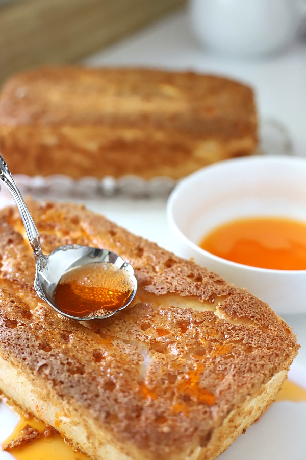 A light dessert and easy recipe for orange angel food cake begins with a box mix. Poke holes throughout the baked cake and pour in Jell-O. Top with whipped topping and serve.