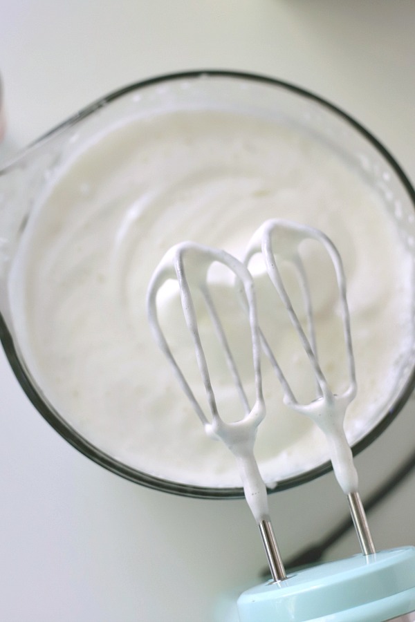 A light dessert and easy recipe for orange angel food cake begins with a box mix. Poke holes throughout the baked cake and pour in Jell-O. Top with whipped topping and serve.