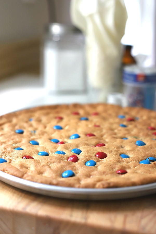 Celebrate the 4th of July with a giant patriotic peanut butter cookie pizza. Easy recipe the whole family will love.