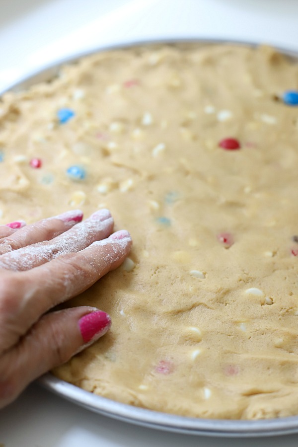 Celebrate the 4th of July with a giant patriotic peanut butter cookie pizza. Easy recipe the whole family will love.