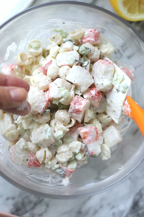 How to make pasta crab salad with veggies, basil, seasonings and fete cheese in a light dressing.