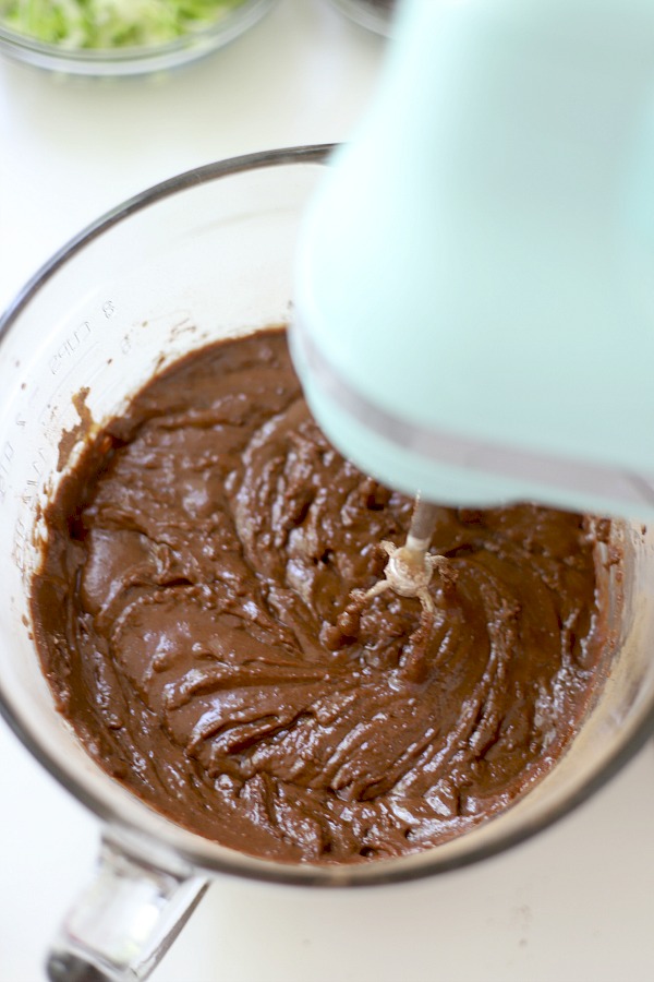 Easy step-by-step recipe for making super moist chocolate zucchini cupcakes with a creamy peanut butter frosting.