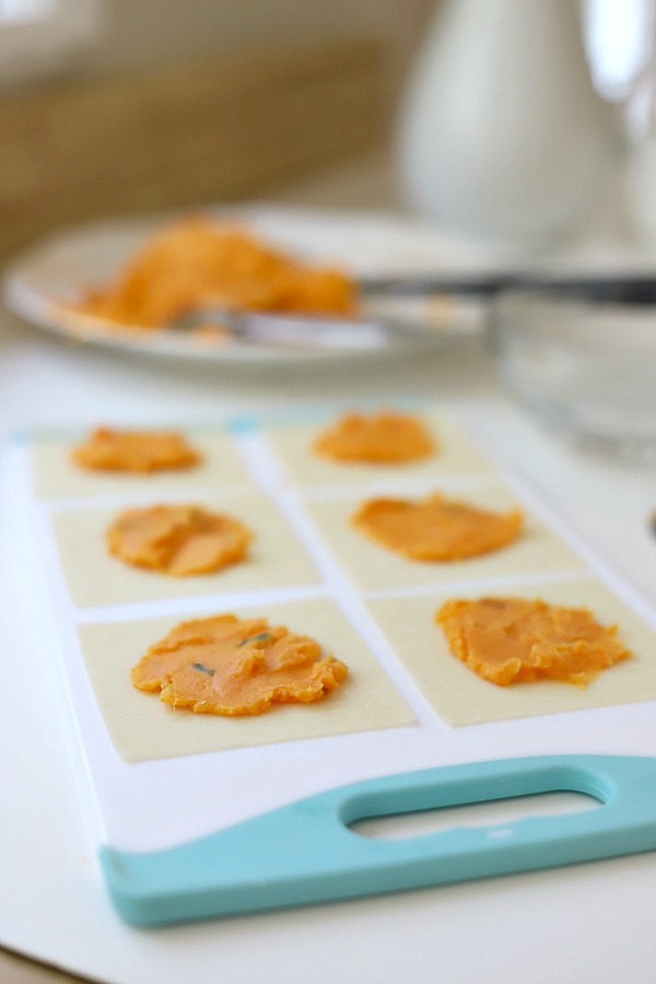 Sweet potato ravioli are pouches of filling in wonton wrappers, served with sage infused cream. An elegant vegetarian dinner entrée sure to please!