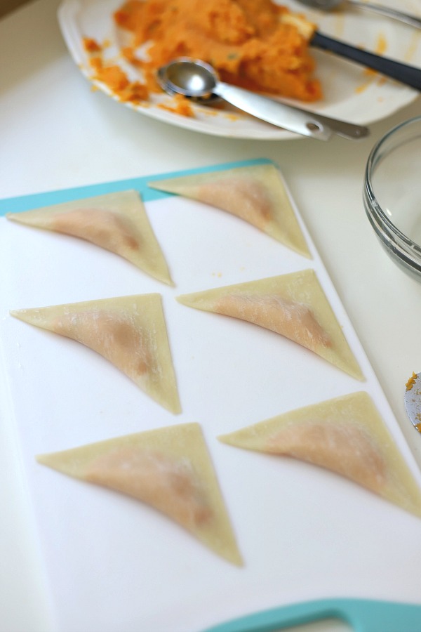 Sweet potato ravioli are pouches of filling in wonton wrappers, served with sage infused cream. An elegant vegetarian dinner entrée sure to please!