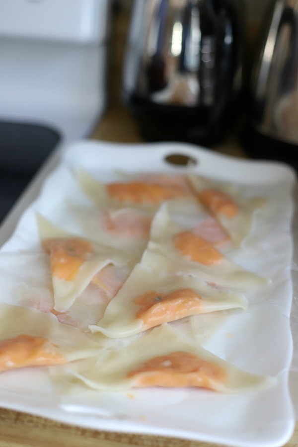 Sweet potato ravioli are pouches of filling in wonton wrappers, served with sage infused cream. An elegant vegetarian dinner entrée sure to please!