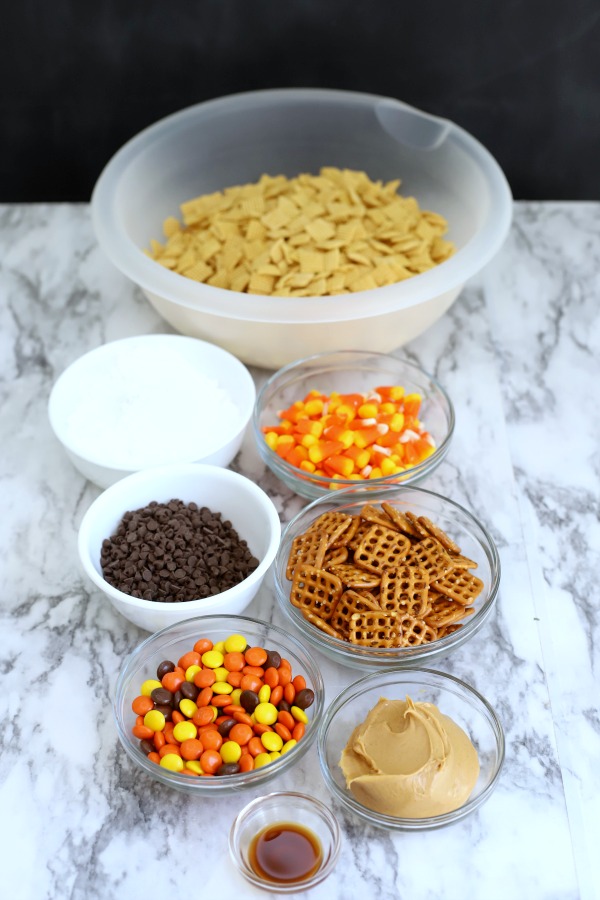 Easy to make, autumn puppy chow is a kid and adult favorite Halloween party snack. Chex mix, chocolate, peanut butter and candy corn tossed with confectioners sugar is a frightfully delicious concoction!