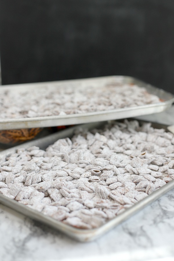 Easy to make, autumn puppy chow is a kid and adult favorite Halloween party snack. Chex mix, chocolate, peanut butter and candy corn tossed with confectioners sugar is a frightfully delicious concoction!