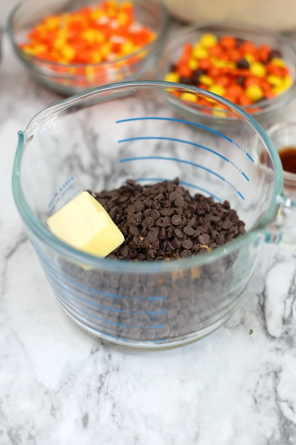 Easy to make, autumn puppy chow is a kid and adult favorite Halloween party snack. Chex mix, chocolate, peanut butter and candy corn tossed with confectioners sugar is a frightfully delicious concoction!