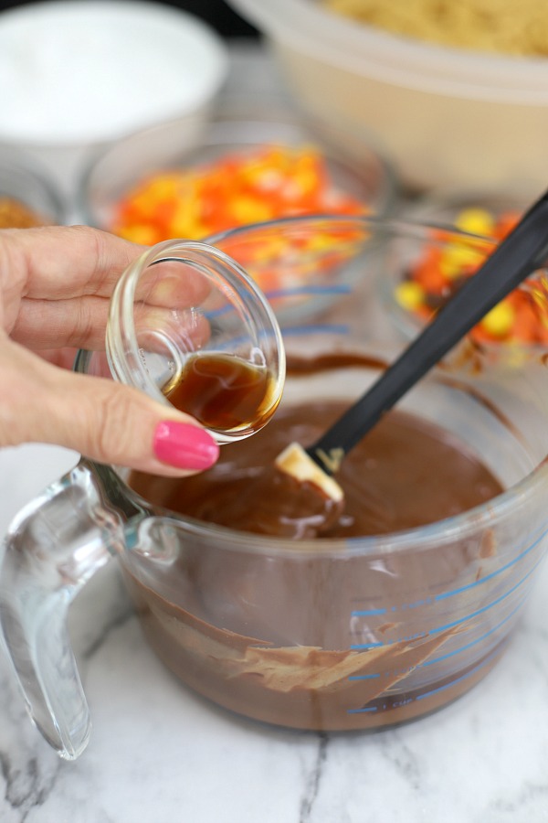 Easy to make, autumn puppy chow is a kid and adult favorite Halloween party snack. Chex mix, chocolate, peanut butter and candy corn tossed with confectioners sugar is a frightfully delicious concoction!