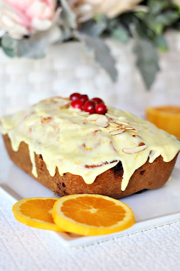 A quick and easy bread, frosted apricot cranberry bread is filled with pieces of chopped cranberries, swirls of apricot preserves and a sweet orange frosting. A perfect side for your Thanksgiving or holiday dinner.