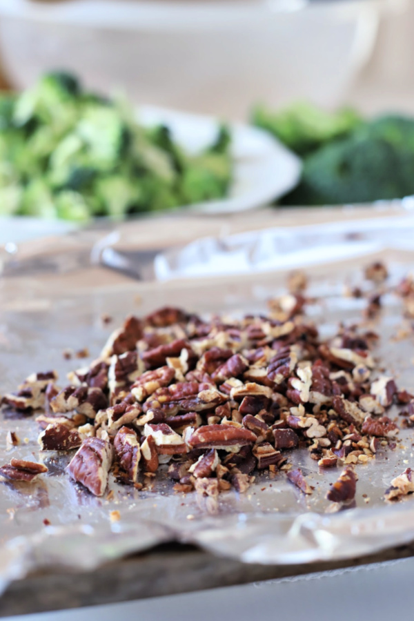 Easy recipe for broccoli grape pasta salad that is tasty, colorful and a perfect side dish or entrée. Tender bow tie pasta is tossed with a creamy, sweet and tangy dressing and topped with toasted pecans and crisp bacon.