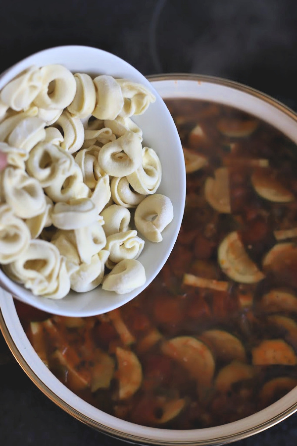 Easy recipe for robust and flavorful Italian sausage soup is a meal in a bowl. Tender vegetables with sausage and tortellini in a tomato broth will warm you soul and tummy.