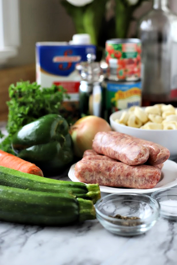 Easy recipe for robust and flavorful Italian sausage soup is a meal in a bowl. Tender vegetables with sausage and tortellini in a tomato broth will warm you soul and tummy.