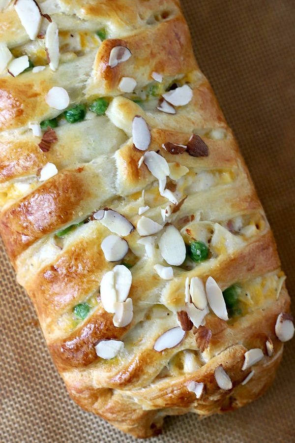 Fancy looking for company brunch or breakfast, crescent chicken braid is baked golden brown with a creamy filling of cheddar cheese and chicken chunks and topped with sliced almonds. Easy recipe using a tube of Pillsbury crescent rolls! A great weeknight family meal too. 