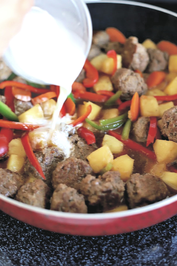 Easy recipe for Sweet and sour meatballs. Bell peppers and carrots are cooked crisp tender and added with pineapple chunks to a lightly tangy sauce. Serve over rice for a great weeknight or family dinner.