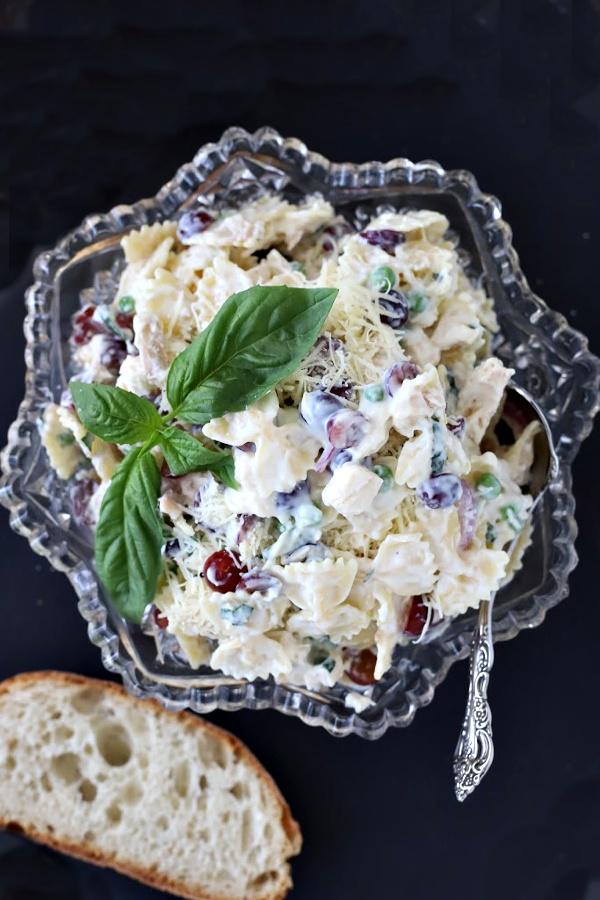 A favorite, creamy chicken pasta salad with parmesan cheese, peas and basil is perfect for potluck food, tasty lunch entrée, cookout side dish or a tasty dinner. So much goodness, it is a meal in itself. Serve with crusty bread and enjoy!