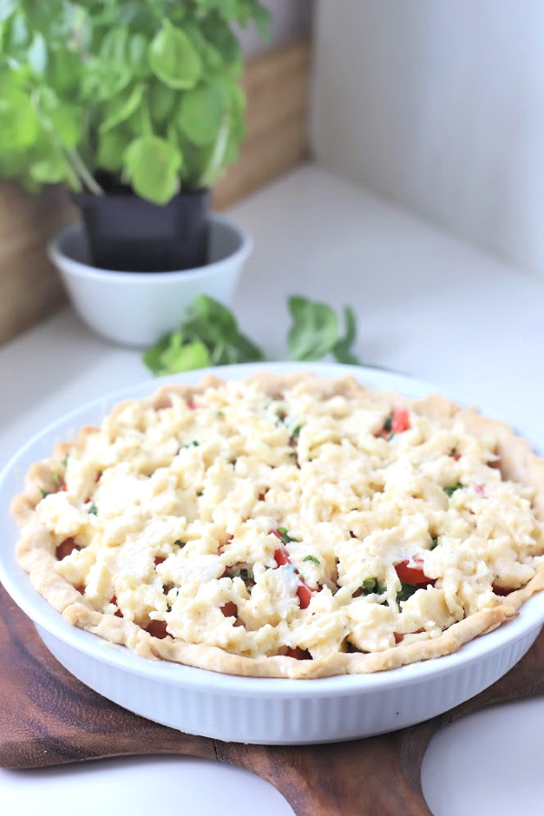 There is something about the flavor combo of fresh tomatoes and basil. An easy recipe that combines creamy Mozzarella and Parmesan cheese in a flaky crust. Basil tomato pie is bright, savory and delicious! Serve as an appetizer or entrée.