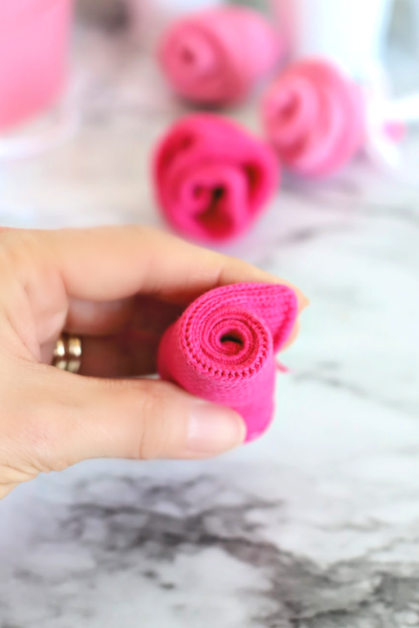 Easy step-by-step how-to for bud roses from baby socks. DIY flowers for shower corsage and décor ideas.