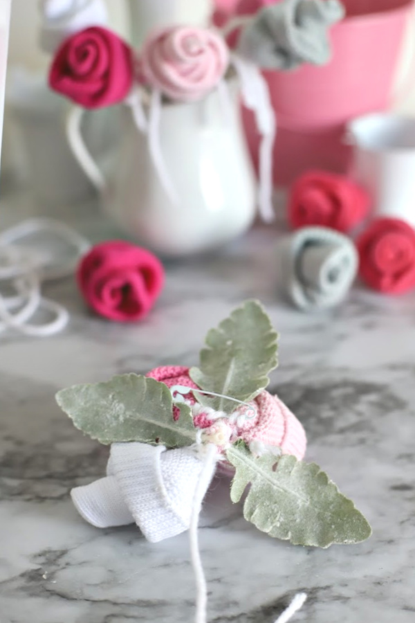 Easy step-by-step how-to for bud roses from baby socks. DIY flowers for shower corsage and décor ideas.