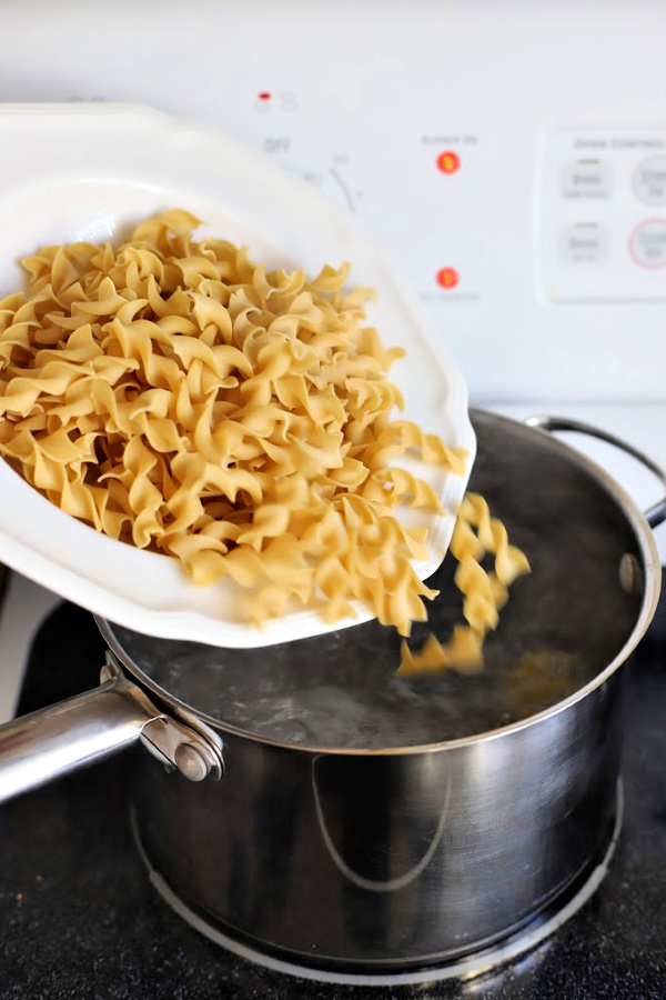 Classic creamy tuna noodle casserole with egg noodles is budget-friendly. Quick and easy recipe using cream of chicken soup, mayo and cheddar cheese. 