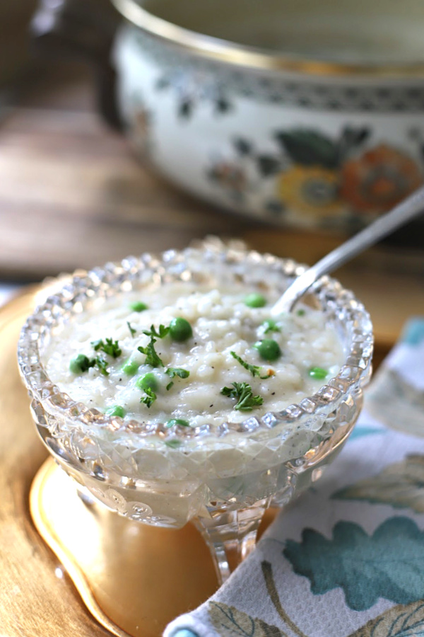 An easier recipe for a baked version of risotto. When al dente, additional stock, Parmesan, butter, wine & peas are stirred in creating a creamy rice dish.