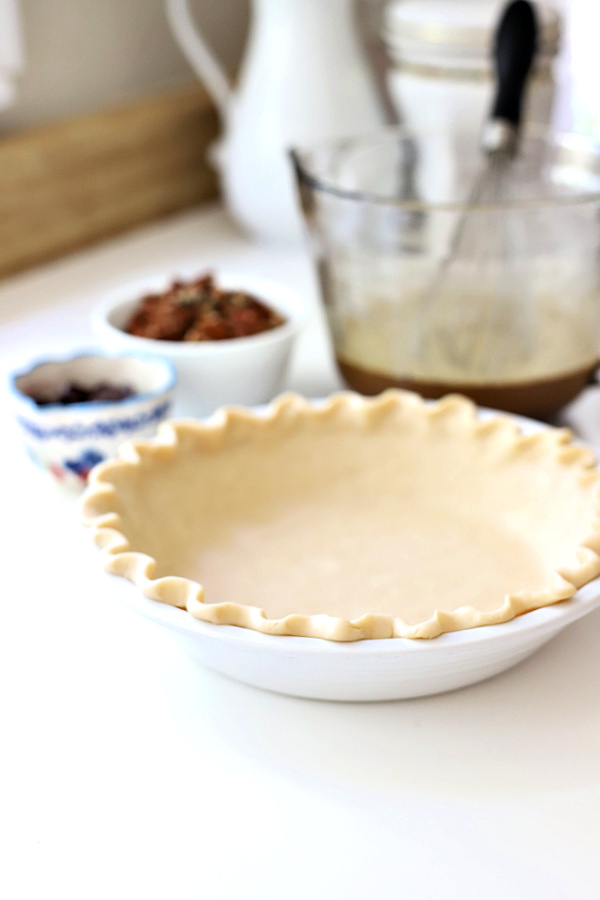 Preparing the crust for a chocolate pecan pie