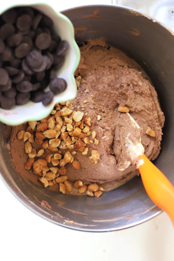 Adding bittersweet morsels and pecans to chocolate peanut butter cookies.