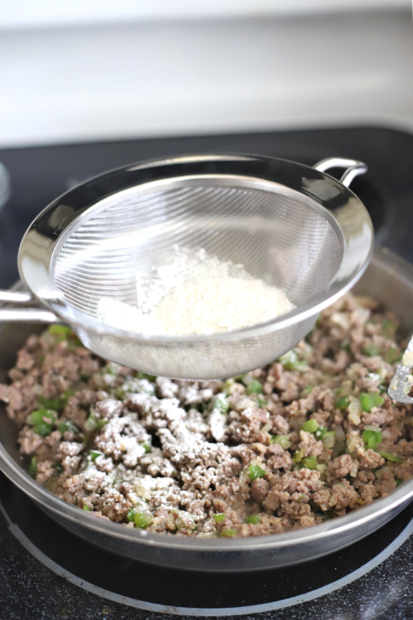 sifting in the flour for sausage gravy