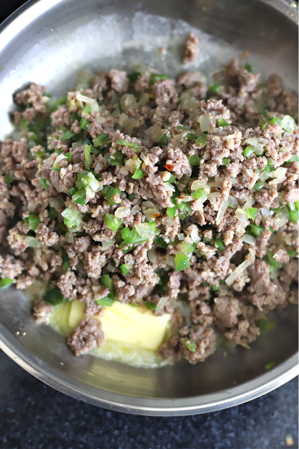 Adding the butter in skillet for sausage gravy