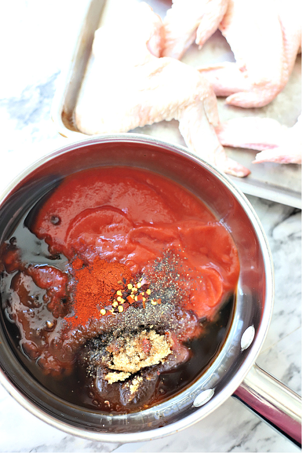 Preparing glaze for making sticky orange chicken wings.