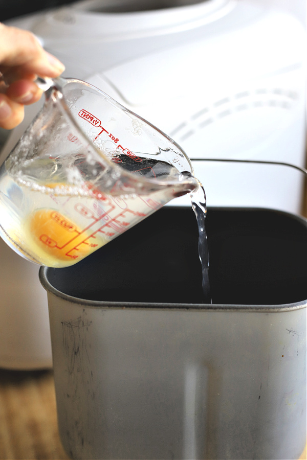 adding egg and water to bread machine