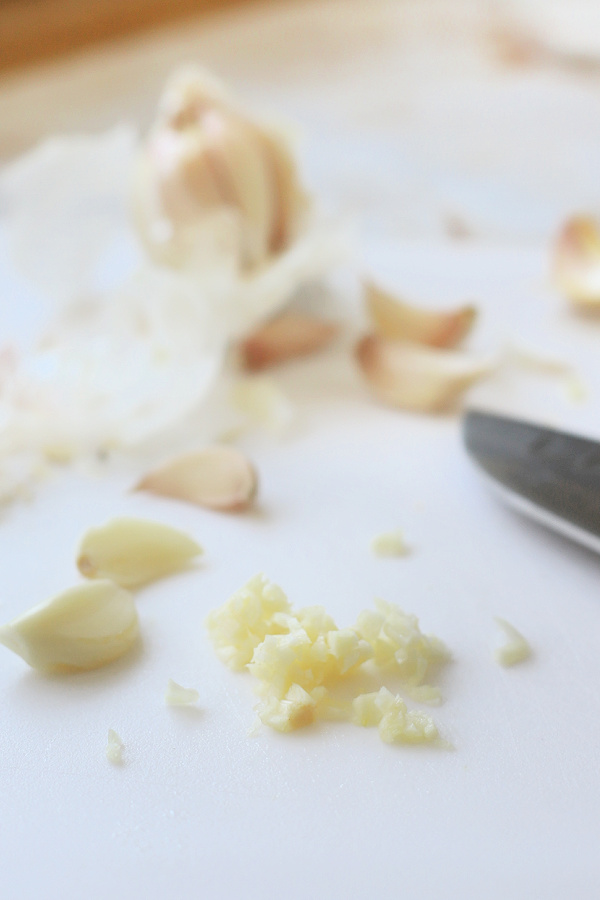 mincing garlic for Tomatoes and feta pasta