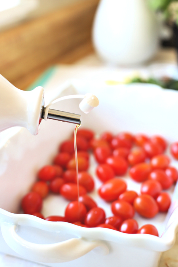 adding olive oil for zesting a lemon for baked tomato & feta.