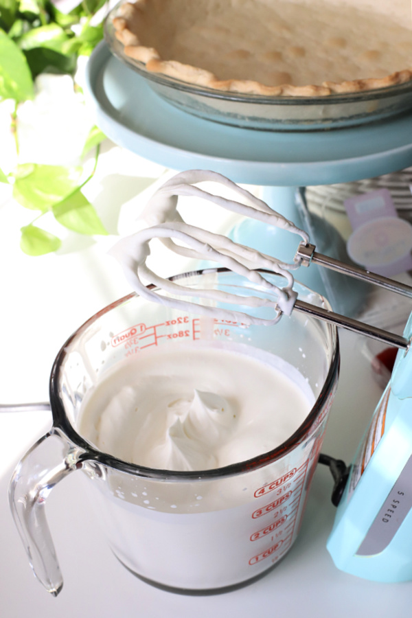 making fresh whipped cream to top chocolate cream pie