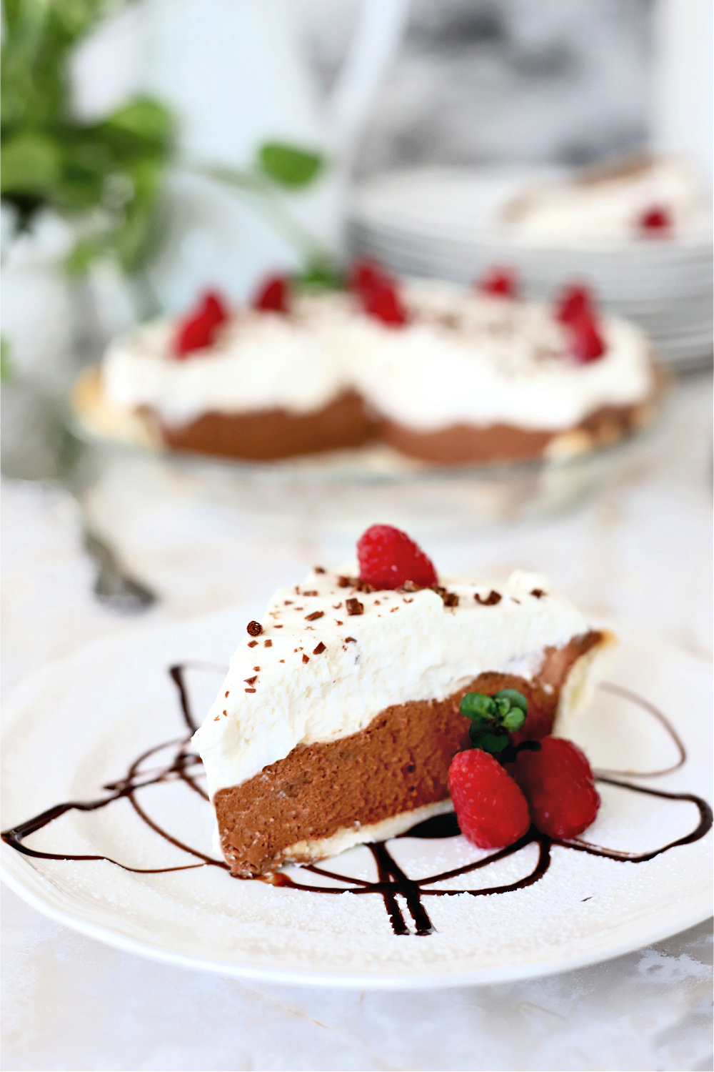 Easy recipe for a creamy, decadent chocolate cream pie with cream cheese and dark chocolate chips using a homemade or refrigerator pie crust. 