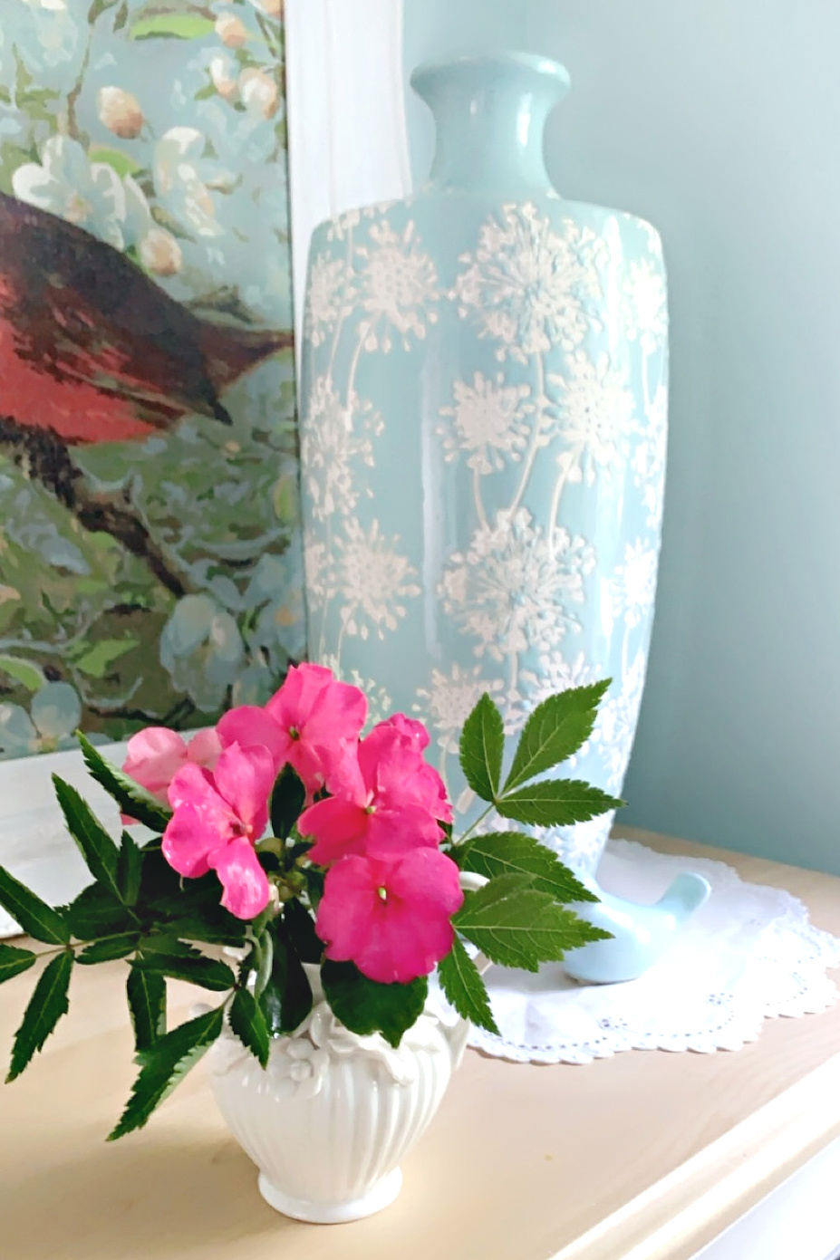 Impatiens gathered after the rain are displayed in a tiny vase to brighten the powder room.