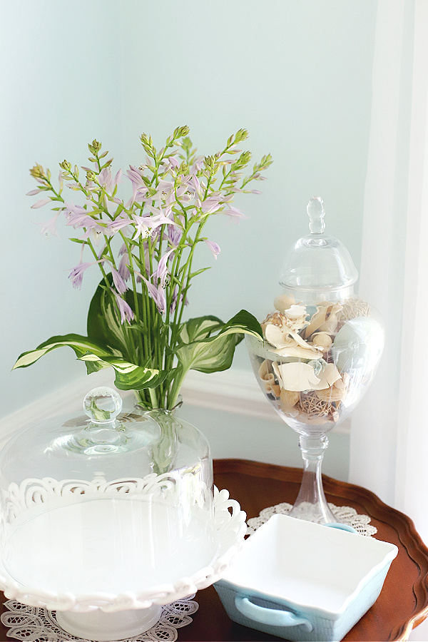 Simple flower arrangement of hosta flowers and leaves