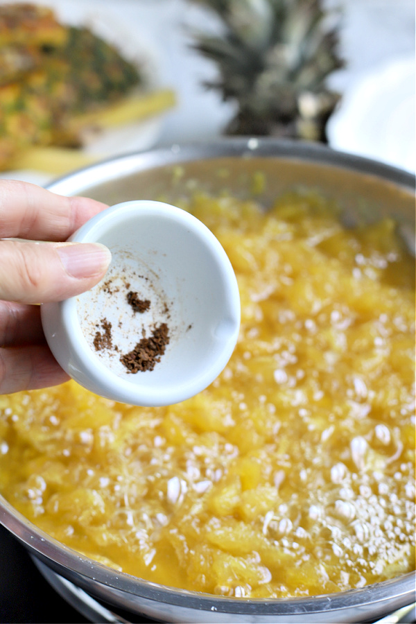 adding cloves to pineapple jam recipe