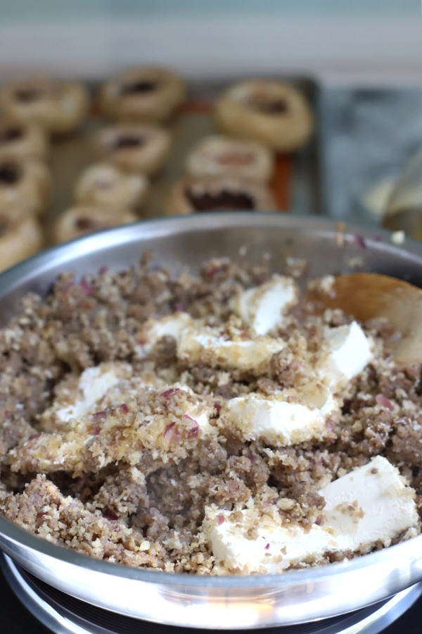 adding softened cream cheese to sausage stuffed mushrooms recipe