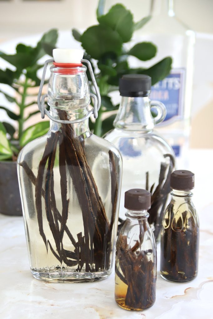 Adding vanilla beans to jars for homemade vanilla extract.