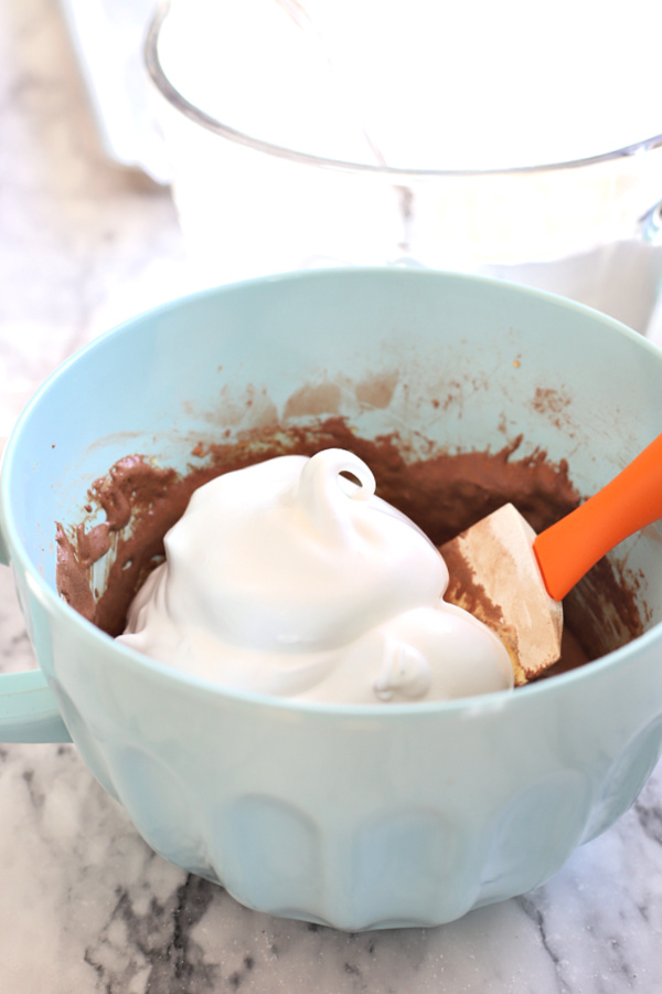 Folding the beaten egg whites into the chocolate mocha mixture.